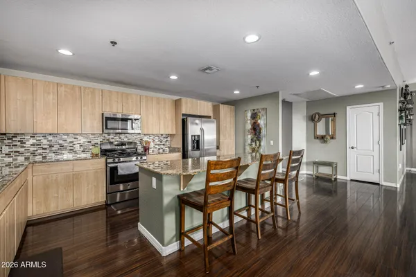 a living room with furniture a fireplace and a chandelier