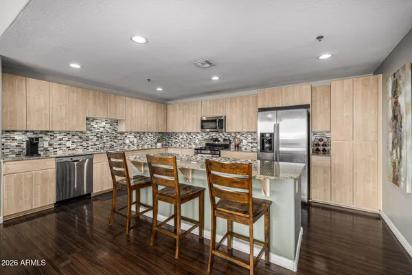 a living room with furniture a fireplace and a large window