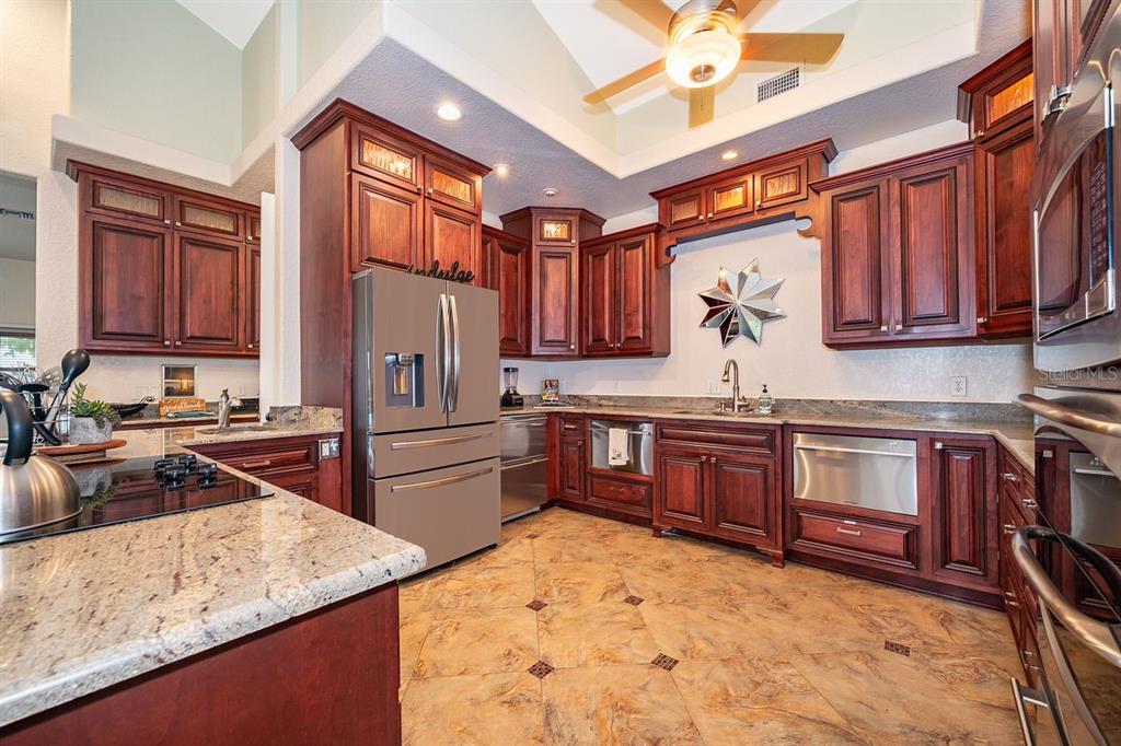 2339 Neptune Road, Unit A Kissimmee, FL 34744 - Photo 11 of 43 a kitchen with stainless steel appliances granite countertop a stove refrigerator sink and cabinets