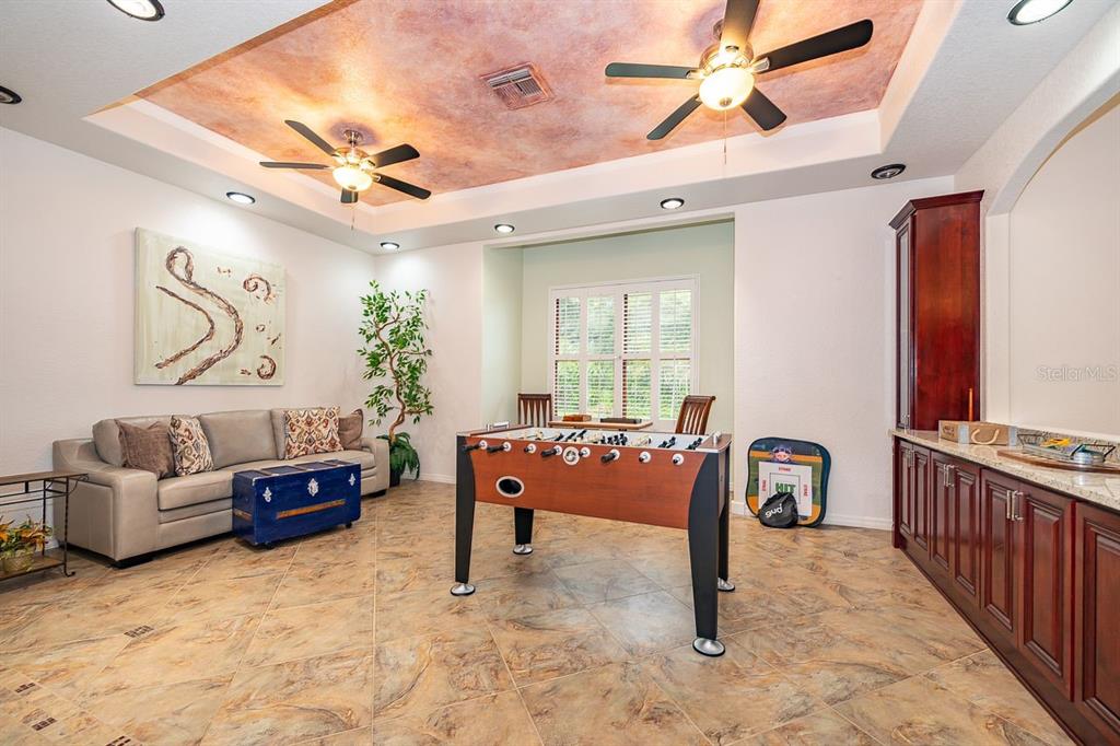 2339 Neptune Road, Unit A Kissimmee, FL 34744 - Photo 19 of 43 a living room with furniture and a chandelier