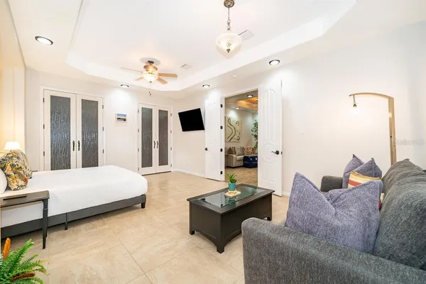 a living room with furniture and a chandelier