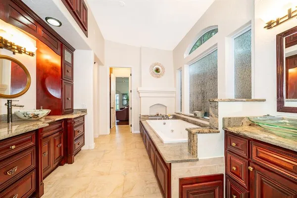 a spacious bathroom with a granite countertop sink and a large mirror
