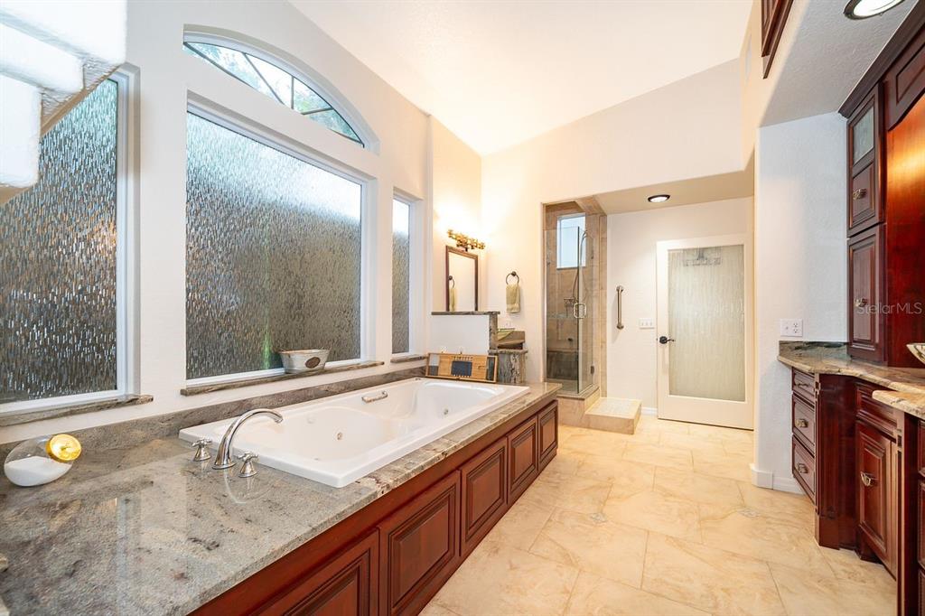 2339 Neptune Road, Unit A Kissimmee, FL 34744 - Photo 24 of 43 a spacious bathroom with a granite countertop double vanity and a mirror