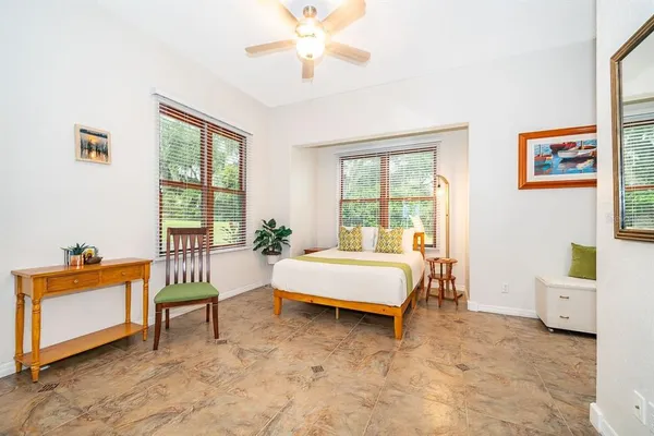 a spacious bedroom with a bed and a window