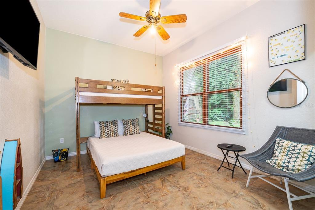 2339 Neptune Road, Unit A Kissimmee, FL 34744 - Photo 30 of 43 a bedroom with a bed chair and a window