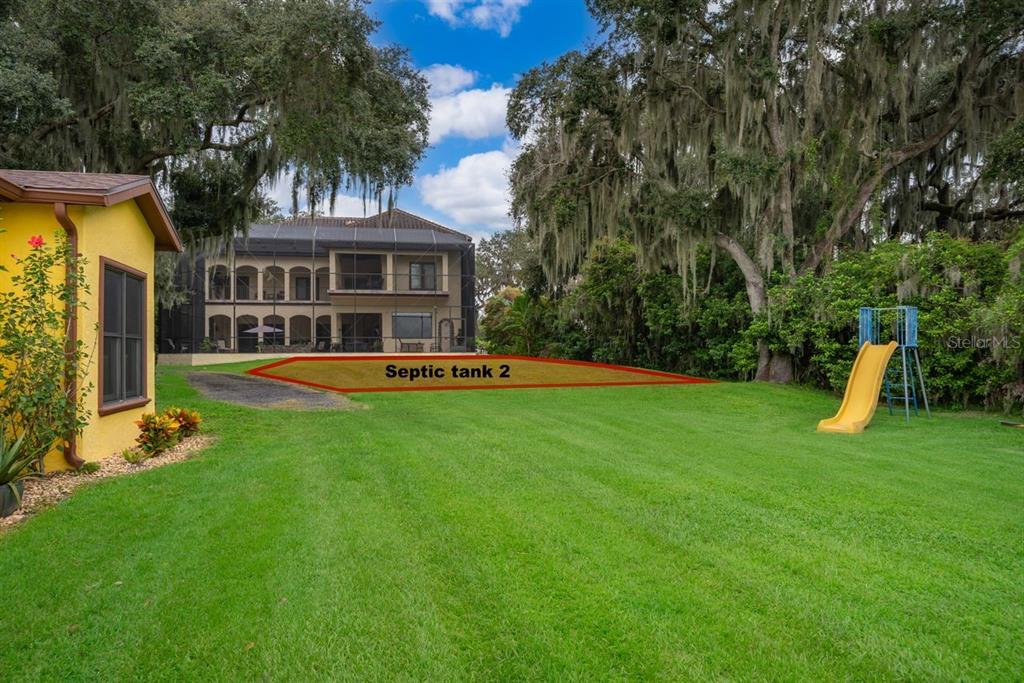 2339 Neptune Road, Unit A Kissimmee, FL 34744 - Photo 37 of 43 a front view of a house with a yard table and chairs