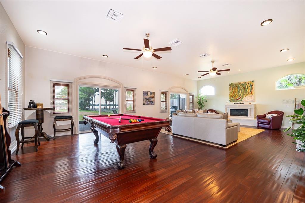 2339 Neptune Road, Unit A Kissimmee, FL 34744 - Photo 4 of 43 a living room with furniture a wooden floor and chandelier