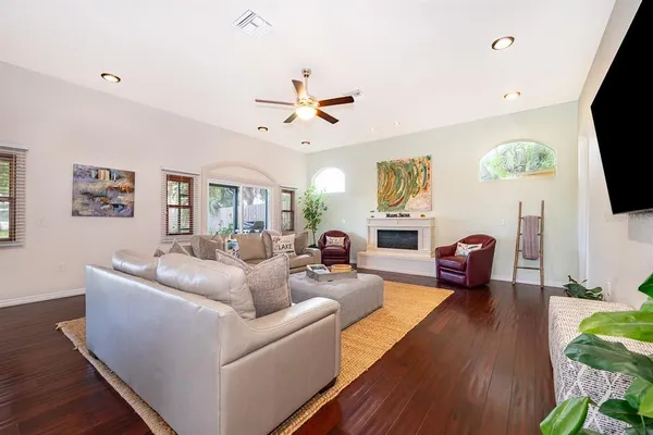 a living room with furniture a flat screen tv and a fireplace