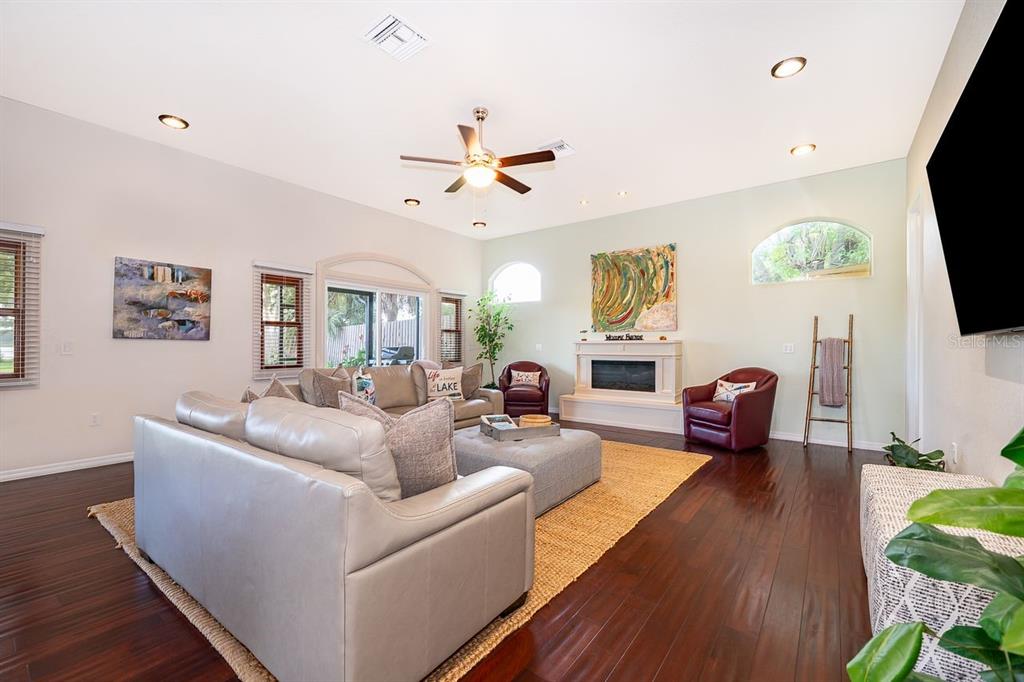 2339 Neptune Road, Unit A Kissimmee, FL 34744 - Photo 8 of 43 a living room with furniture a flat screen tv and a fireplace