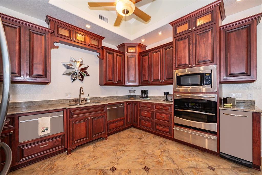 2339 Neptune Road, Unit A Kissimmee, FL 34744 - Photo 10 of 43 a kitchen with stainless steel appliances granite countertop a stove sink and cabinets