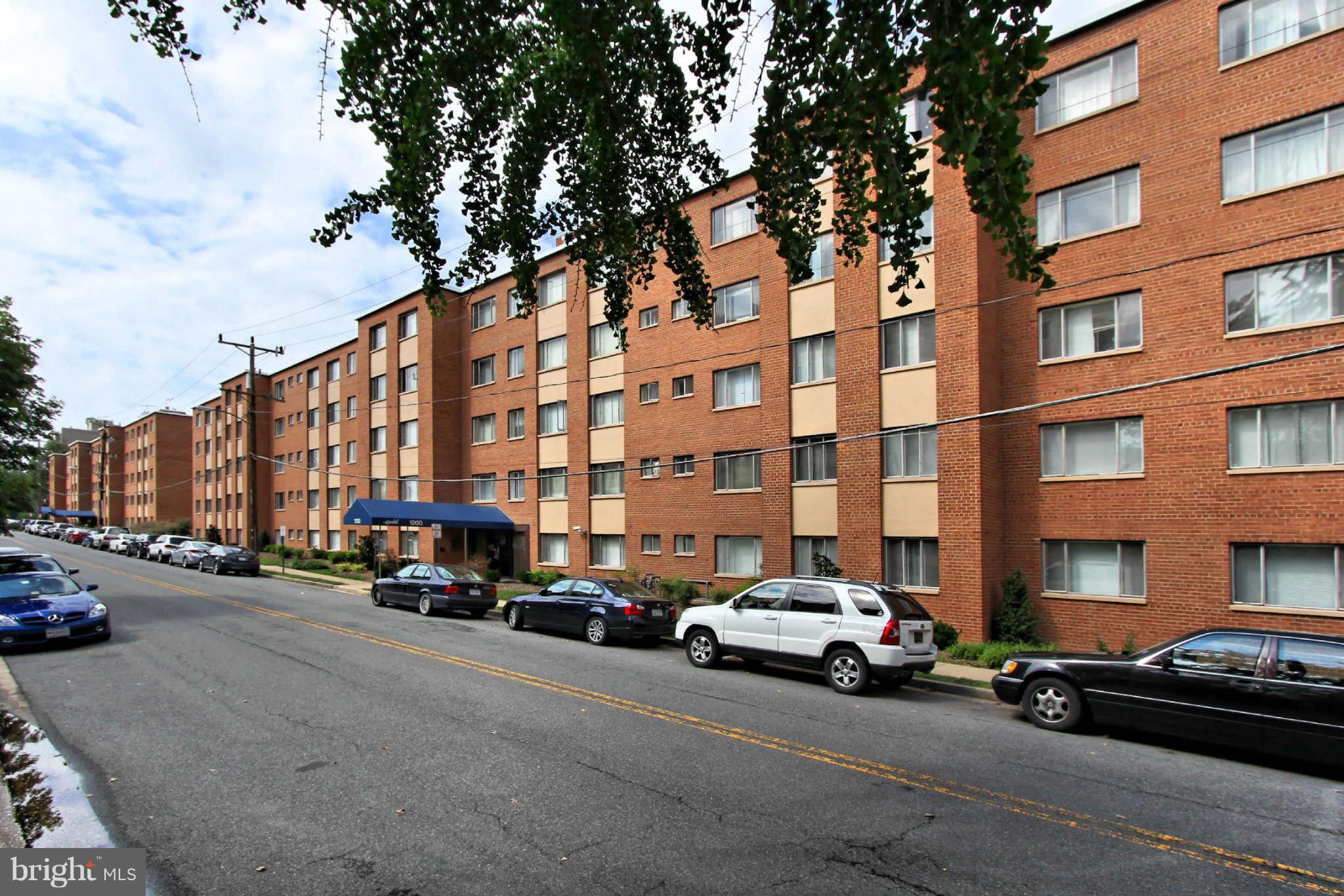 1300 South Arlington Ridge Road, Unit 201 Arlington, VA 22202 - Photo 5 of 29 a city street lined with parked cars and buildings