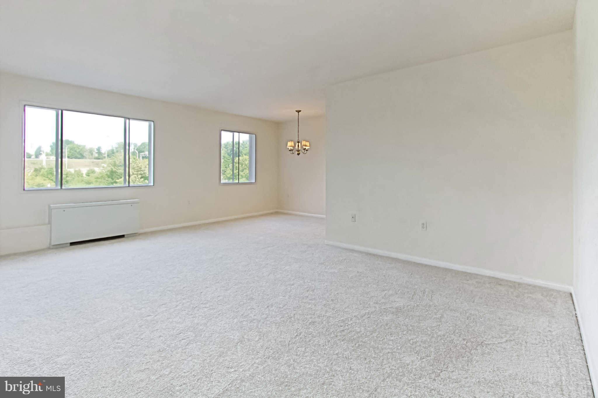 1300 South Arlington Ridge Road, Unit 201 Arlington, VA 22202 - Photo 8 of 29 an empty room with windows
