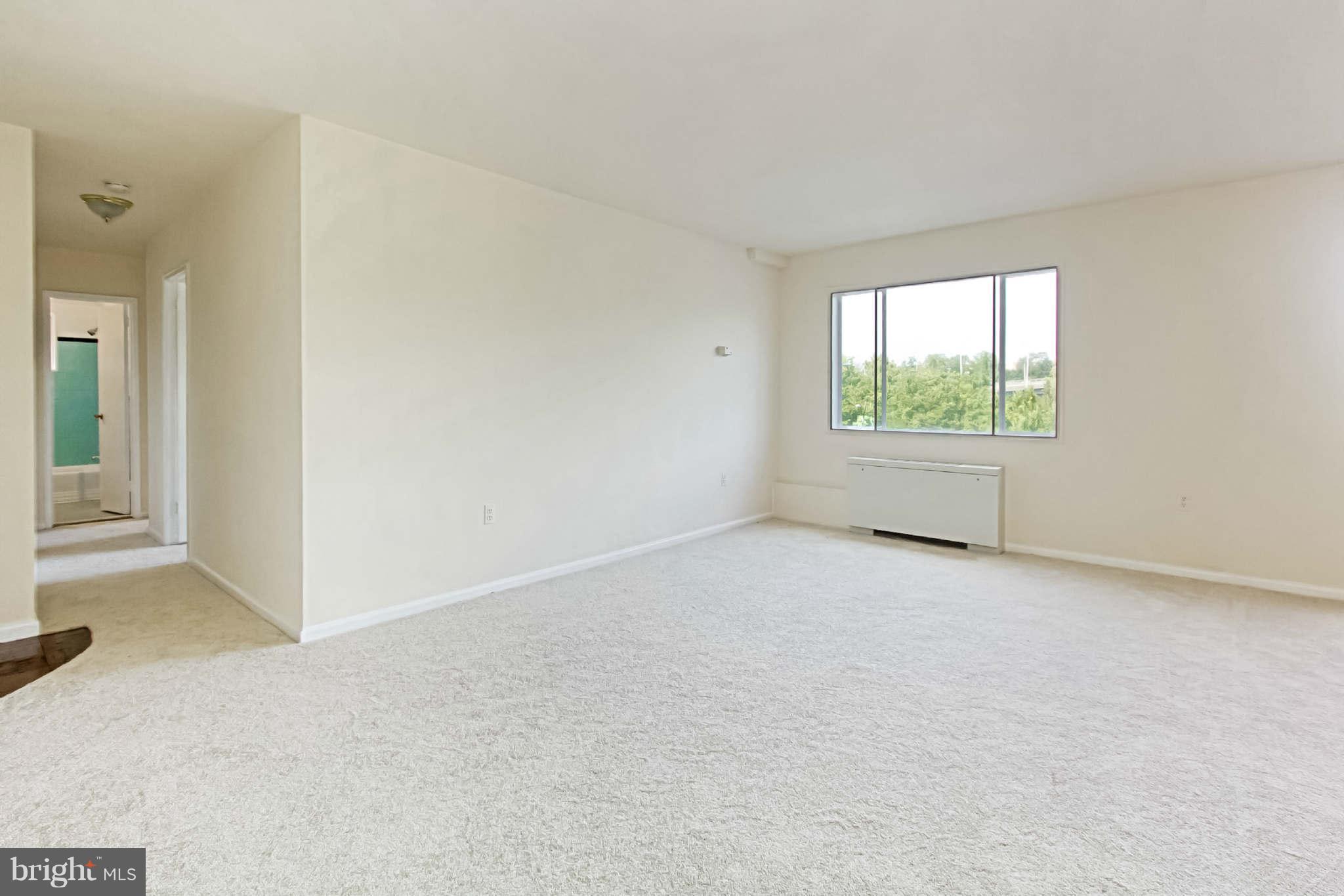 1300 South Arlington Ridge Road, Unit 201 Arlington, VA 22202 - Photo 9 of 29 an empty room with windows