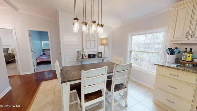 a kitchen with kitchen island a stove and a chandelier