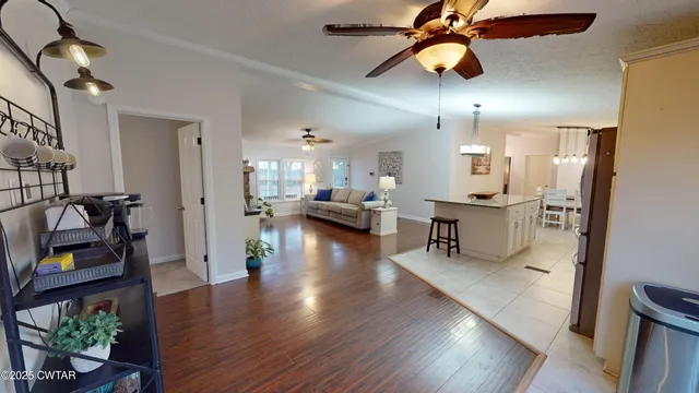 a view of a room with wooden floor and ceiling fan