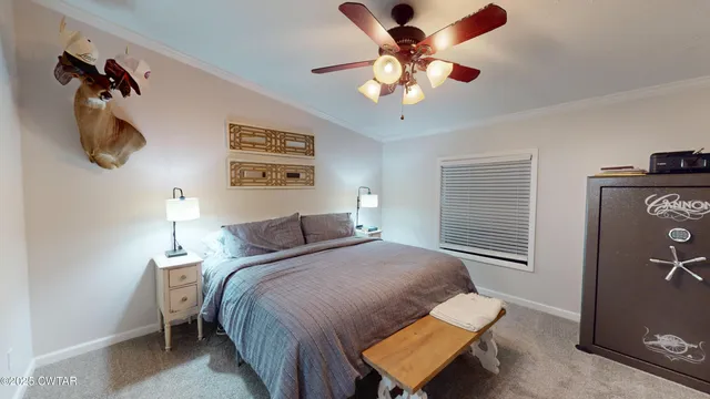 a bedroom with a large bed and a chandelier