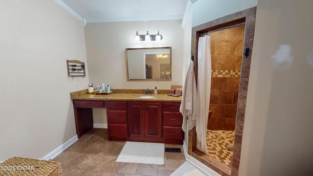 a bathroom with a granite countertop sink toilet and mirror
