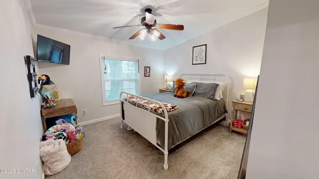 a bedroom with bed and a chandelier