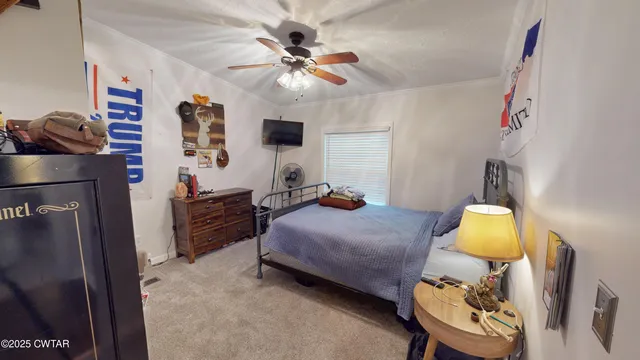 a bedroom with bed and a chandelier