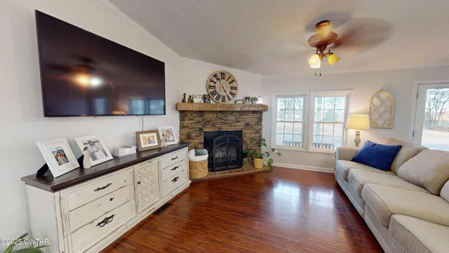 a living room with furniture a fireplace and a flat screen tv