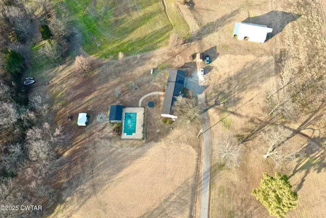 a view of a backyard with two chairs and a table