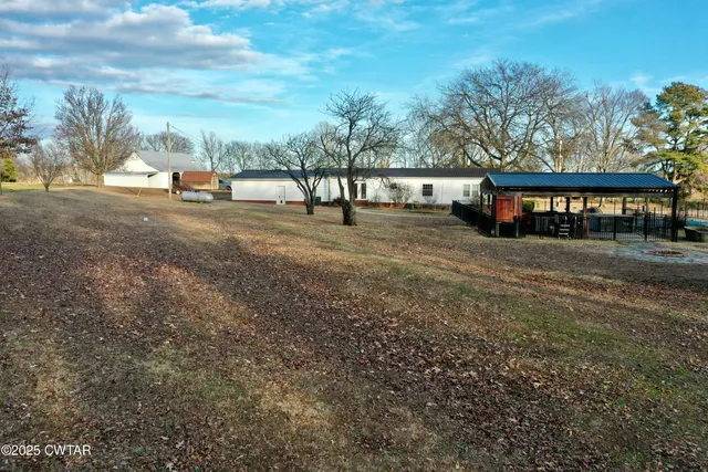 a view of the patio with table and chairs a barbeque