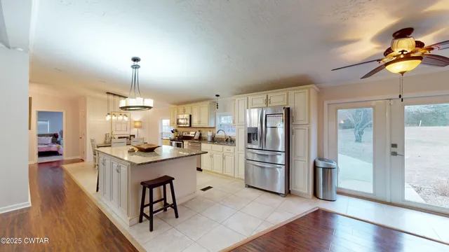 a kitchen with refrigerator cabinets and wooden floor