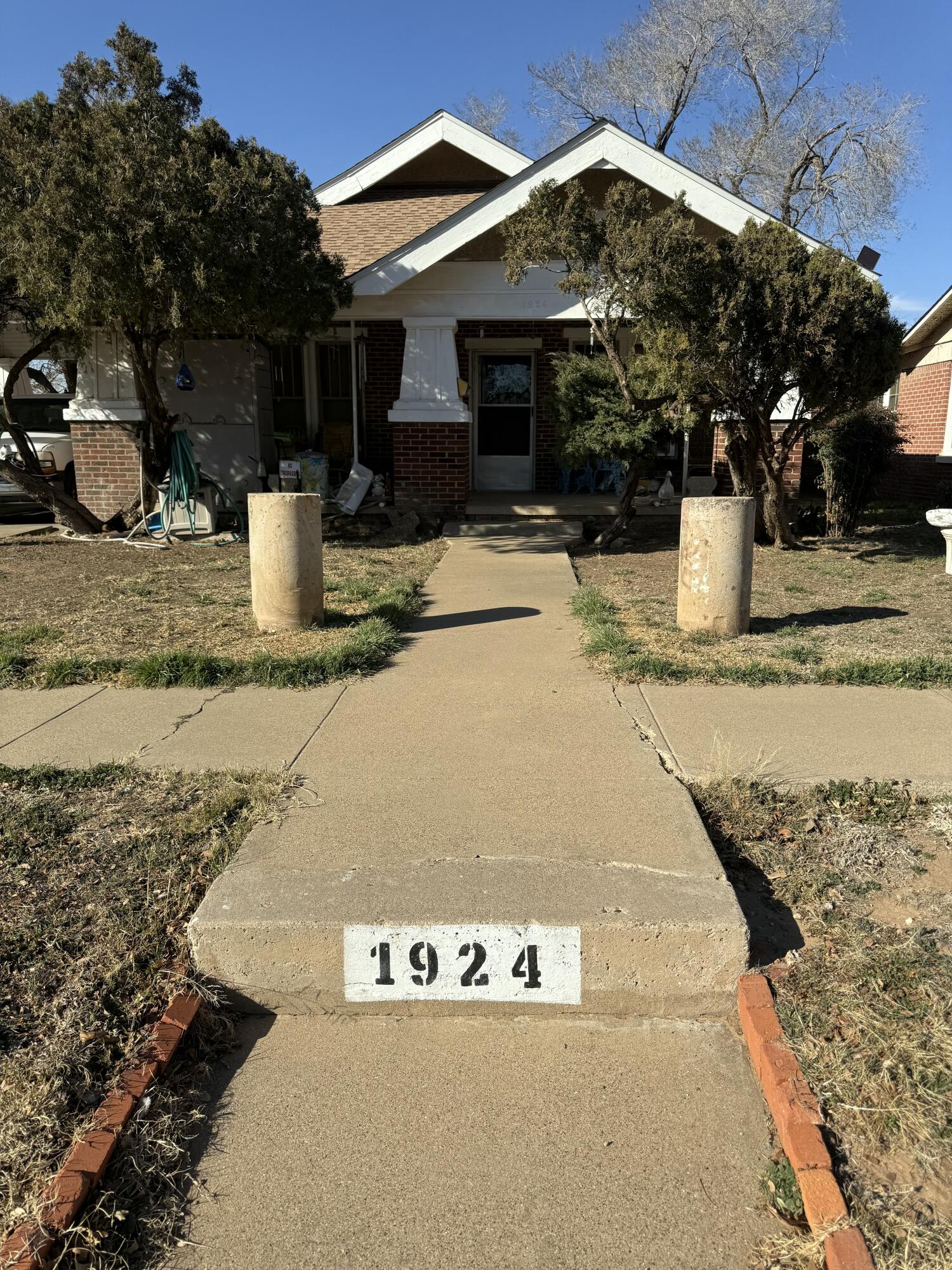 1924 14th Street Lubbock, TX 79401 - Photo 1 of 39 a view of a white house with large tree