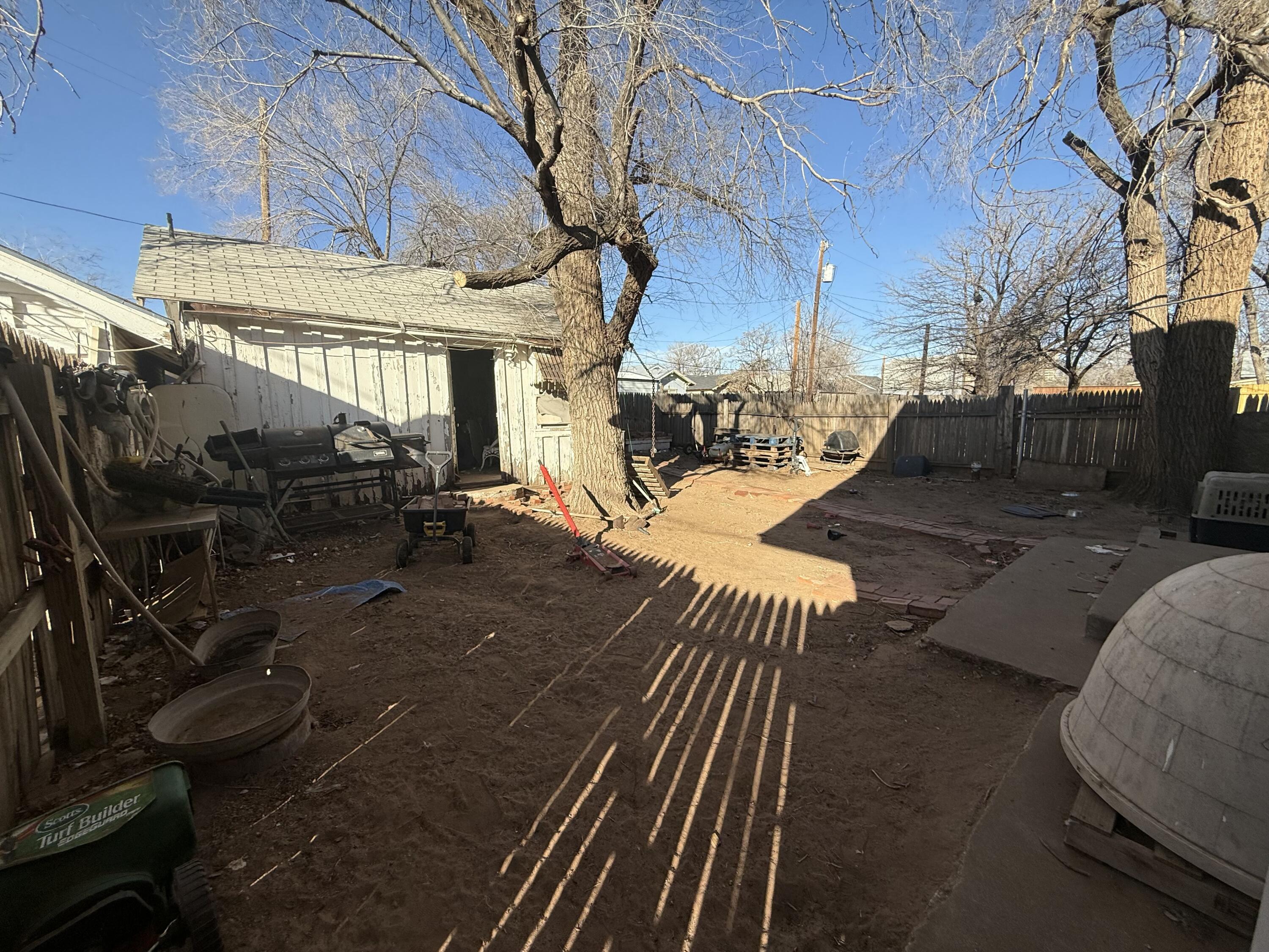 1924 14th Street Lubbock, TX 79401 - Photo 14 of 39 a view of a patio with table and chairs with wooden floor and fence