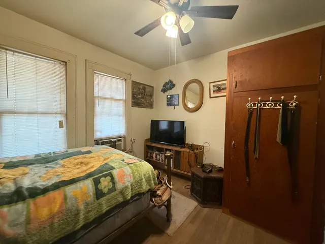 a bedroom with a bed and a chandelier
