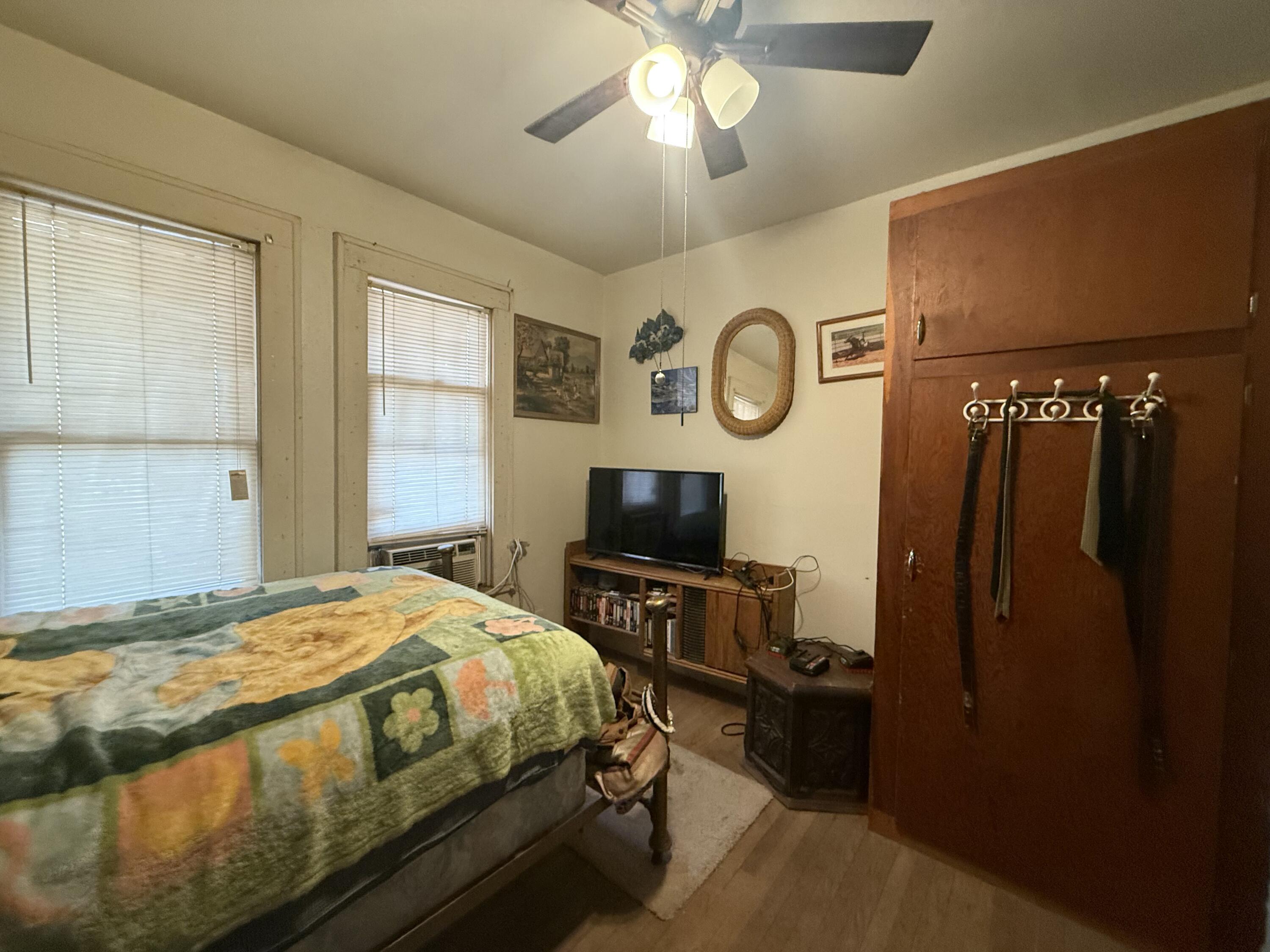 1924 14th Street Lubbock, TX 79401 - Photo 18 of 39 a bedroom with a bed and a chandelier