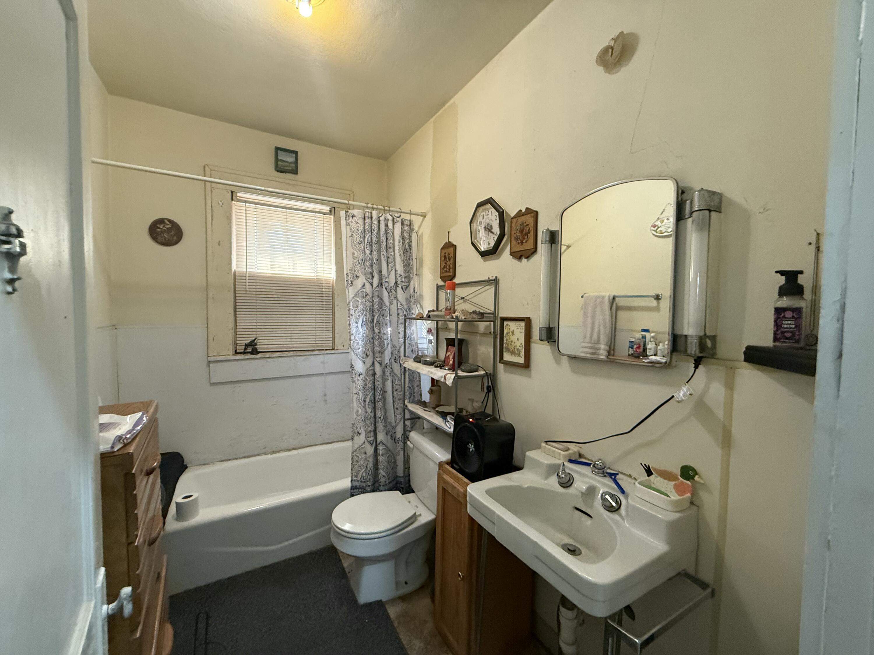1924 14th Street Lubbock, TX 79401 - Photo 20 of 39 a bathroom with a toilet sink and mirror