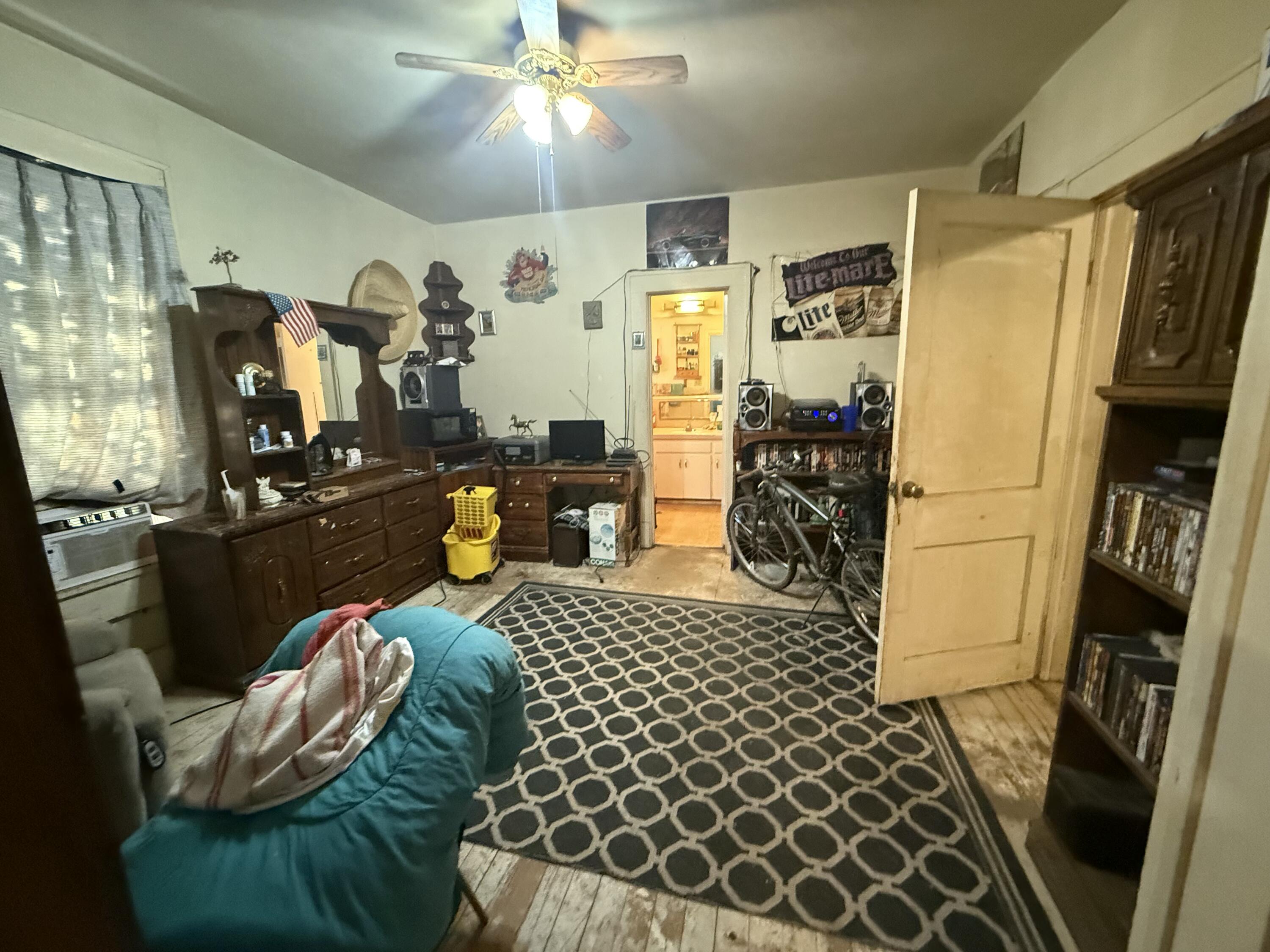 1924 14th Street Lubbock, TX 79401 - Photo 23 of 39 a bedroom with furniture and a chandelier
