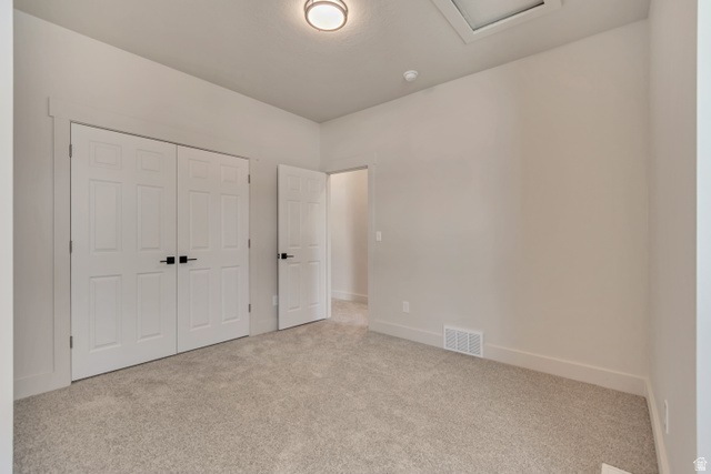 2535 West Santa Fe Drive Mapleton, UT 84664 - Photo 20 of 26 Unfurnished bedroom featuring light colored carpet and a closet