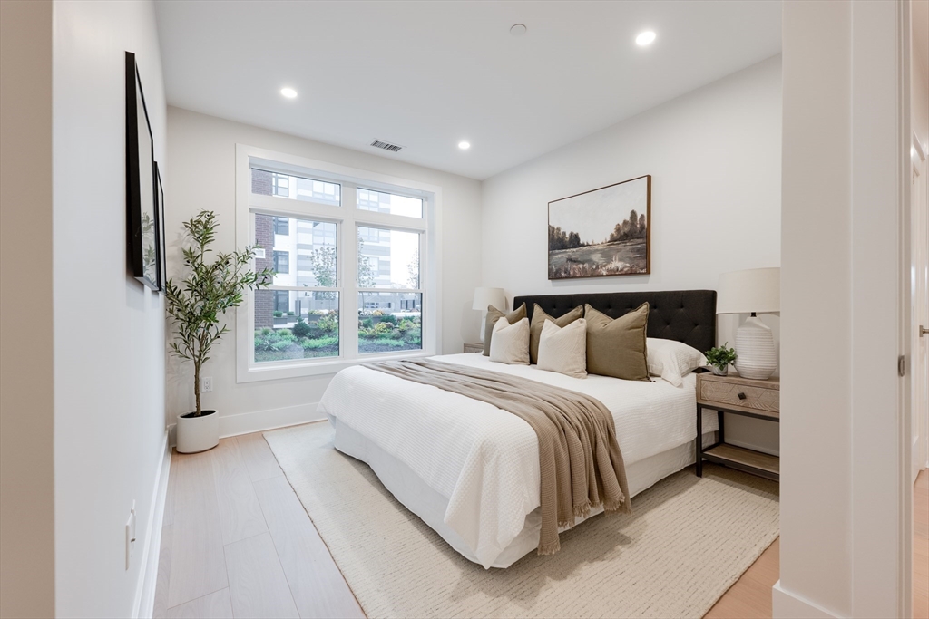 62 Foundry Street, Unit 202 Wakefield, MA 01880 - Photo 13 of 18 a bedroom with a large bed and a large window