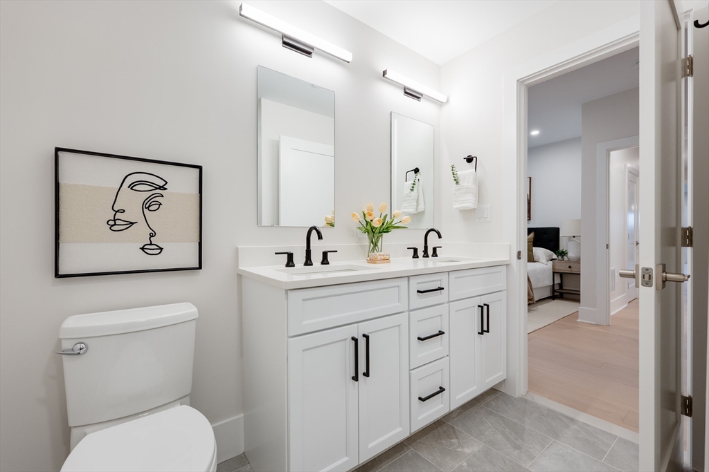 62 Foundry Street, Unit 202 Wakefield, MA 01880 - Photo 14 of 18 a spacious bathroom with a toilet sink and mirror