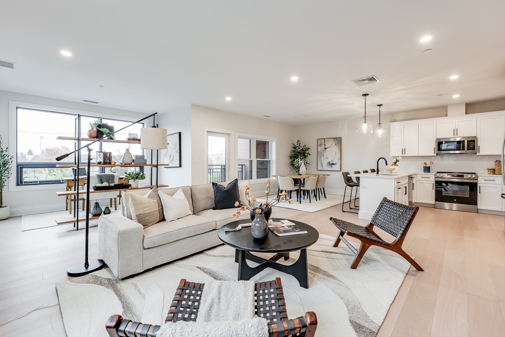 62 Foundry Street, Unit 202 Wakefield, MA 01880 - Photo 10 of 18 a living room with lots of furniture and kitchen view
