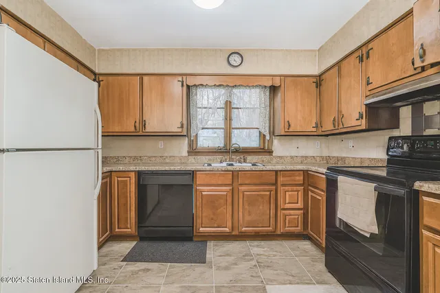 a kitchen with stainless steel appliances granite countertop a stove sink and cabinets