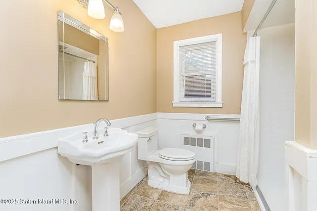 a bathroom with a sink toilet and mirror