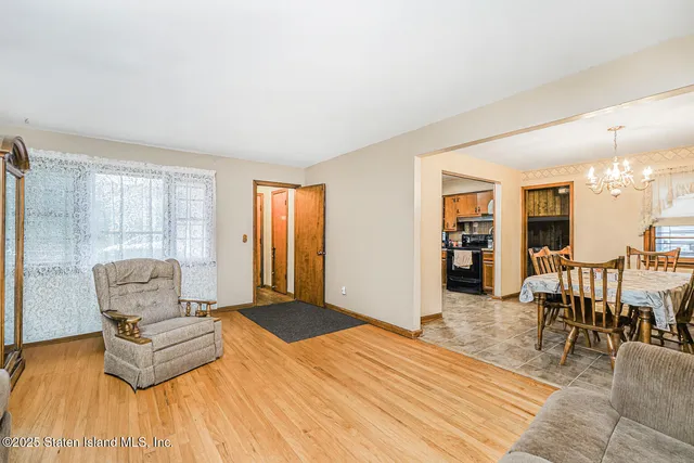 a bedroom with furniture and wooden floor