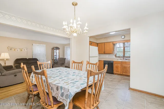 a view of a dining room with furniture and a chandelier