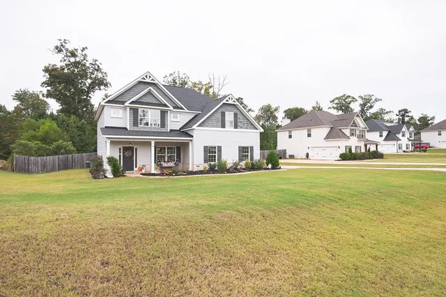 a front view of a house with a garden