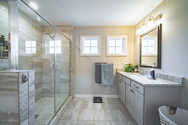 a bathroom with a tub sink and mirror