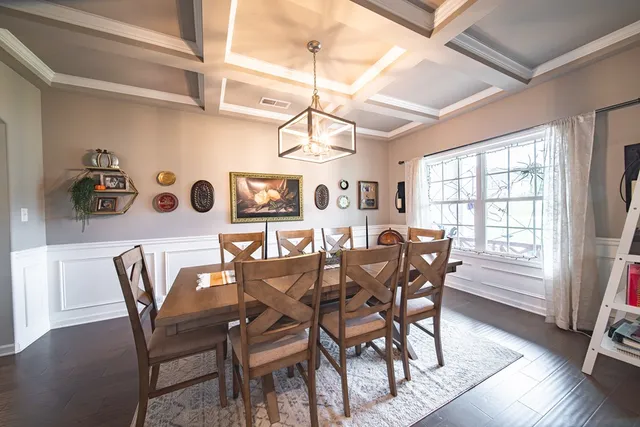 a dining room with furniture and window