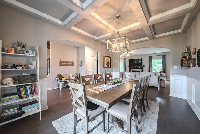 a view of a dining room with furniture and a chandelier