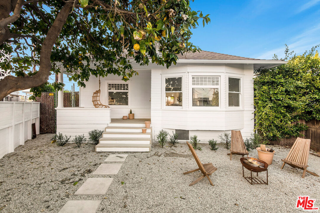 a view of a house with backyard porch and sitting area