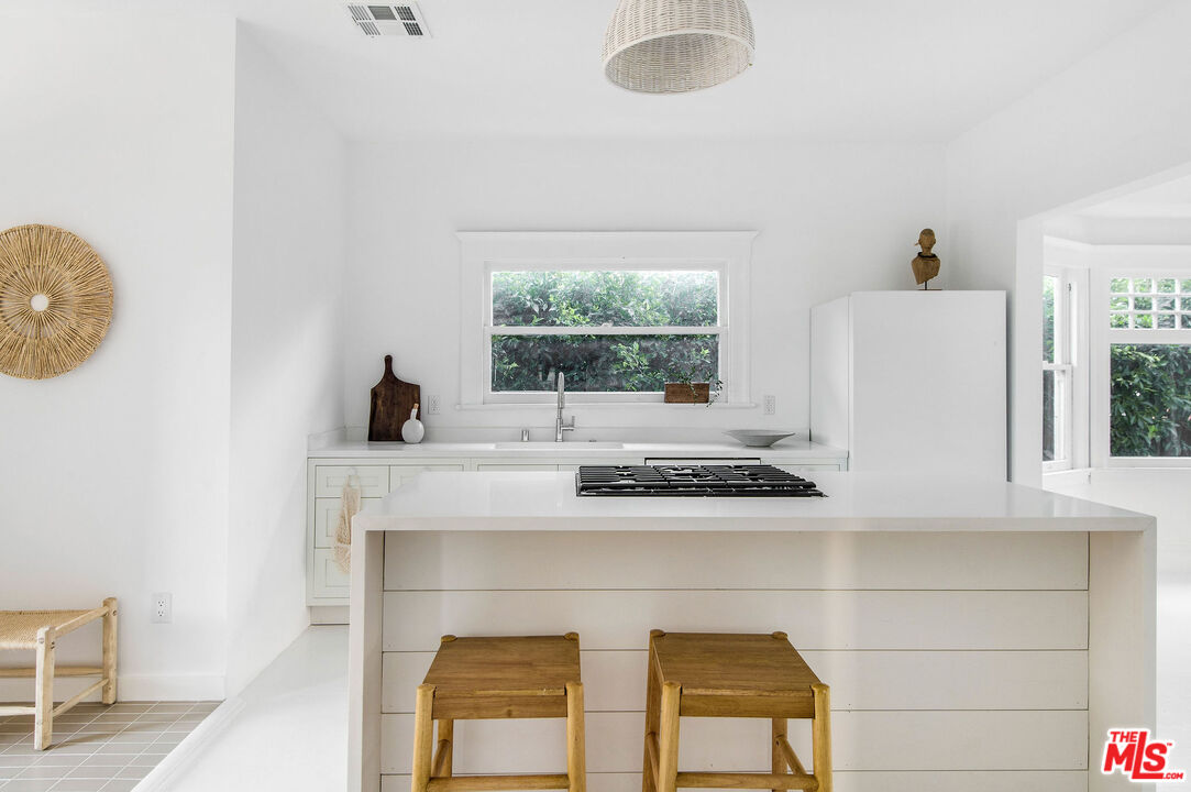 1163 Nelrose Avenue Venice, CA 90291 - Photo 12 of 32 a kitchen with a stove a window and a table