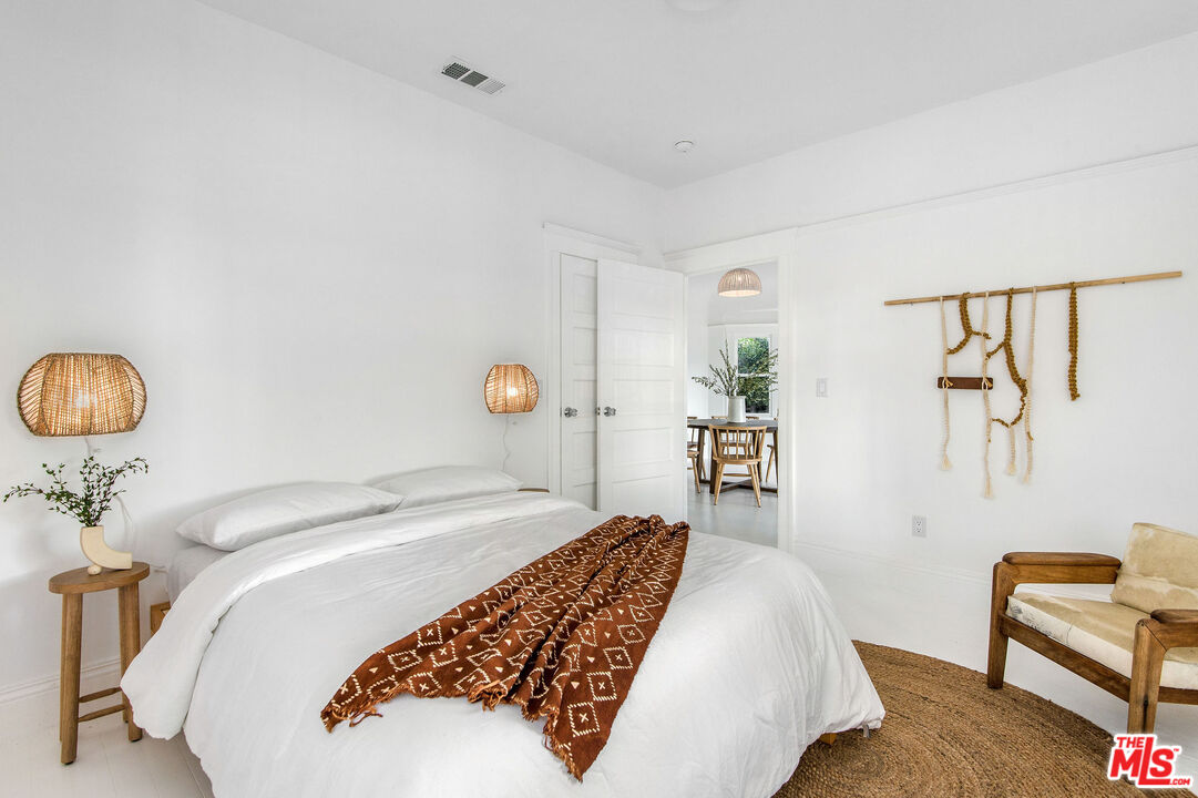 1163 Nelrose Avenue Venice, CA 90291 - Photo 14 of 32 a bedroom with a bed and a chair