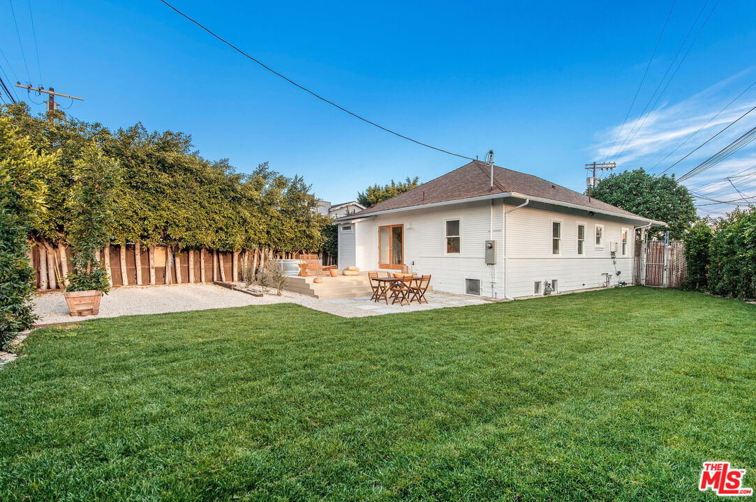 1163 Nelrose Avenue Venice, CA 90291 - Photo 29 of 32 a view of a white house with a big yard and large trees