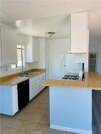 a kitchen with stainless steel appliances granite countertop a sink and a stove